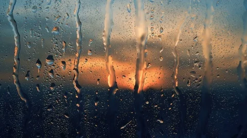 Beautiful sunrise while raining. Watching the sunrise behind the window. 4K Stock Footage 83822550