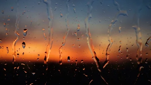 Beautiful sunrise while raining. Watching the sunrise behind the window. 4K Stock Footage 83822969