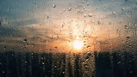 Beautiful sunrise while raining. Watching the sunrise behind the window. 4K Video stock 84255931