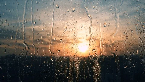Beautiful sunrise while raining. Watching the sunrise behind the window. 4K Stock Footage 84294667