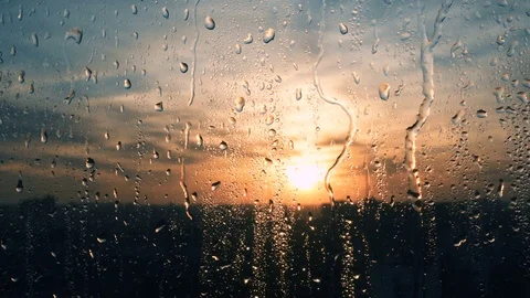 Beautiful sunrise while raining. Watching the sunrise behind the window. 4K Stock Footage 84295374