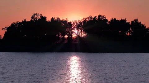 Beautiful Sunrise/Sunset over Lake with Trees Stock Footage