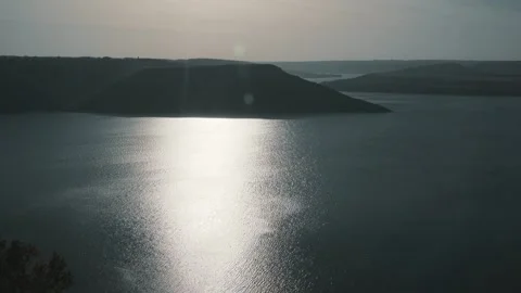 Beautiful sunset against the background of the river and hills Stock Footage 256293526