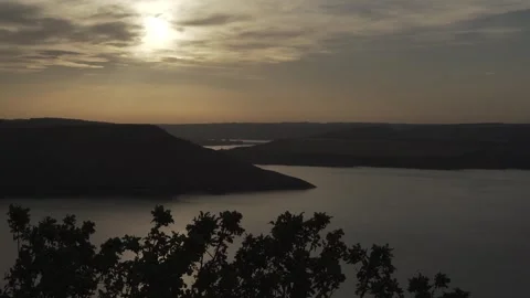 Beautiful sunset against the background of the river and hills Stock Footage 256293617