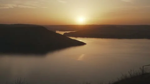 Beautiful sunset against the background of the river and hills Stock Footage 256786066