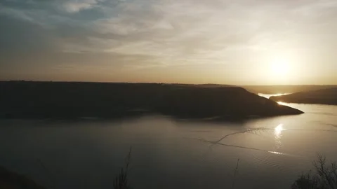 Beautiful sunset against the background of the river and hills Stock Footage 256786161