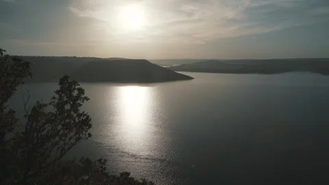 Beautiful sunset against the background of the river and hills Stock Footage 257347648