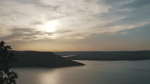 Beautiful sunset against the background of the river and hills Stock Footage 257347817