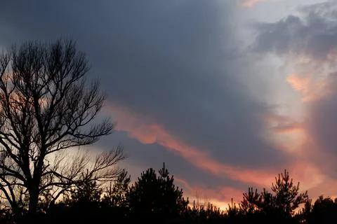 Beautiful sunset and dramatic clouds on the sky. Stock Photos