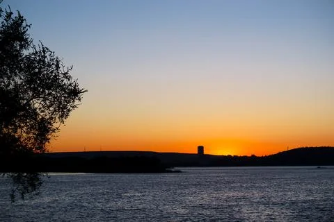 Beautiful sunset on the background of the river Stock Photos