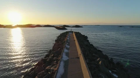 Beautiful sunset background while flying over a pier Stock Footage 114490219