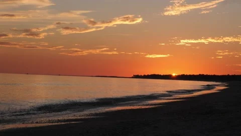 Beautiful sunset at a beach with calm waves Stock Footage 166373284