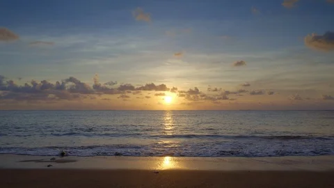 Beautiful sunset beach with waves and blue sky and people crossing Stock Footage 113268661