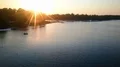 Beautiful sunset beams reflecting in river water, people enjoying relax on boats 4k or 4k+ Resolution