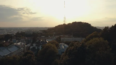 Beautiful sunset Behind small Hill, covered with green Trees, Majestic Nature Stock Footage 121783823