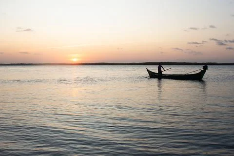 Beautiful sunset with a boat on the river Stock Photos