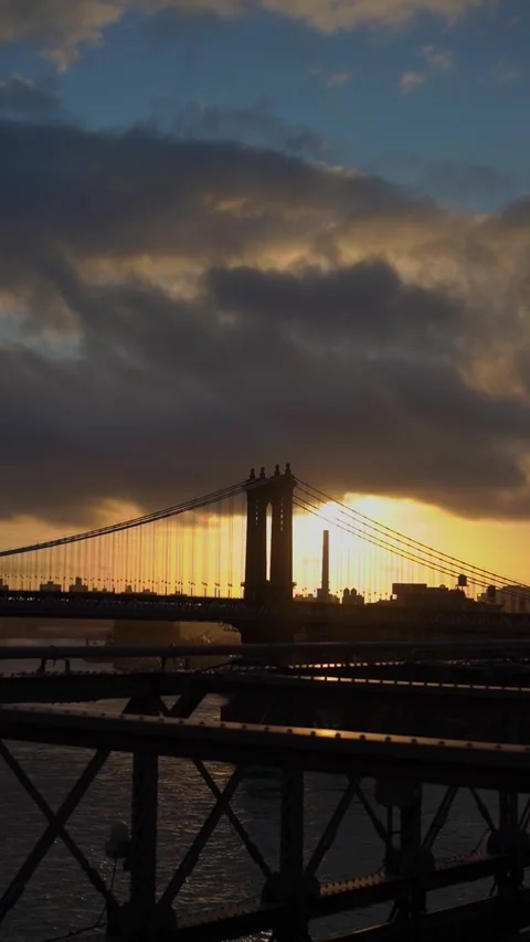 Beautiful sunset casts a warm glow over the bridge and river landscape Vídeo Stock 291617603