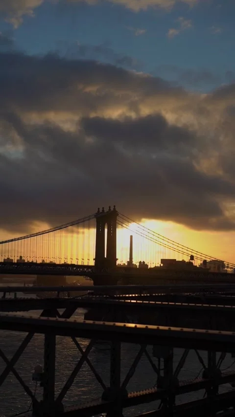Beautiful sunset casts a warm glow over the bridge and river landscape Vídeo Stock 295013348