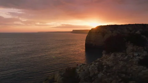 Beautiful sunset on cliffs aerial view sun rays through clouds portugal lagos Stock Footage 196142199