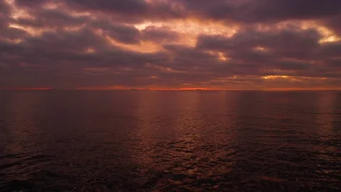 Beautiful sunset with clouds aerial drone shot over the ocean in 4k Stock-Footage 119548573