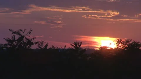 A beautiful sunset, clouds colored and trees, Stock-Footage 11887253