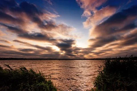 Beautiful sunset with clouds in the foreground Stock Photos
