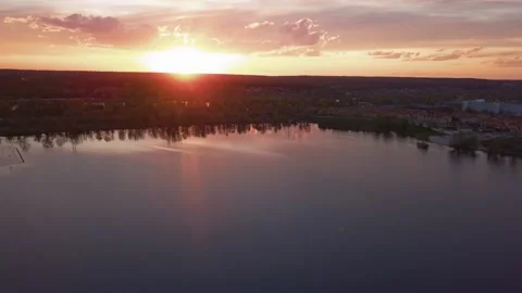 Beautiful sunset with clouds over the river under construction houses in the Stock Footage 157473961