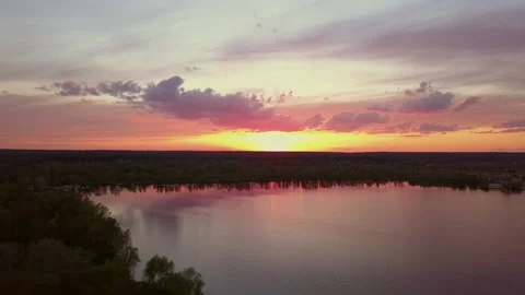 Beautiful sunset with clouds over the river under construction houses in the Stock Footage 157623469