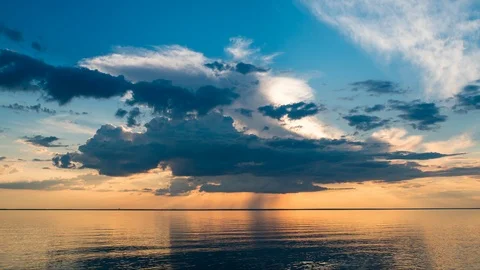 Beautiful sunset clouds over the water of the ocean. Storm clouds in the Stock Footage 113156922