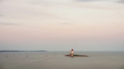 Beautiful sunset on coastline with powerful lighted lighthouse; Beidaihe, China. Stock Footage 57792872