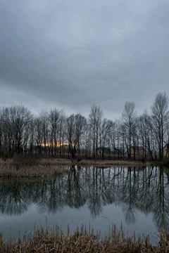 Beautiful sunset with dramatic clouds and reflections in the water during b.. Stock Photos