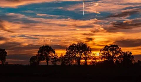 Beautiful sunset with dramatic clouds near Tabertshausen, Bavaria, Germany... Stock Photos