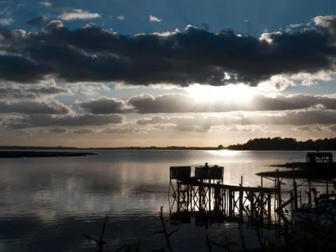 Beautiful sunset dramatic clouds sky dock harbour pier river lake empty Stock Photos