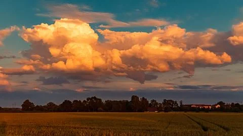 Beautiful sunset with a dramatic sky and overland high voltage lines near ... Stock Photos