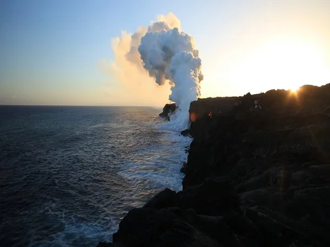 Beautiful sunset at Kilauea volcanic park with steam cloud rising from ocean Stock Footage