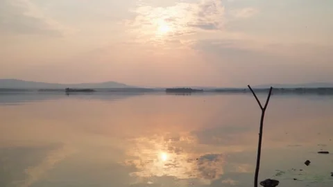 Beautiful sunset on the lake. Mirror reflection of the sky. Stock Footage 242285272