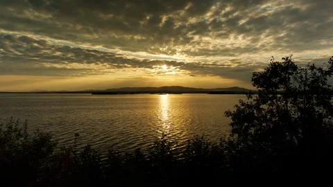 Beautiful sunset on the lake. Reflection and shine of sunlight on the water. Stock Footage 317253572
