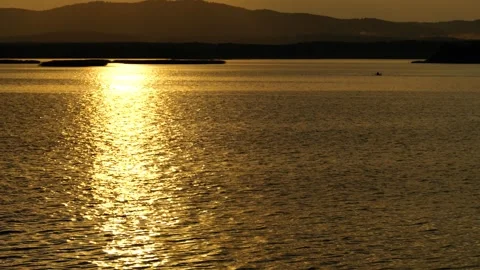Beautiful sunset on the lake. Reflection of sunlight on water. Stock Footage 317252568