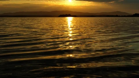 Beautiful sunset on the lake. Reflection of sunlight on water. Stock Footage 317252789