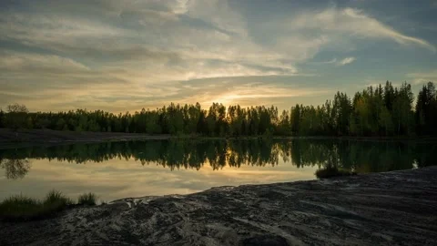 Beautiful sunset on the lake in springtime. Eroded ground in the foreground. Stock Footage 154342759