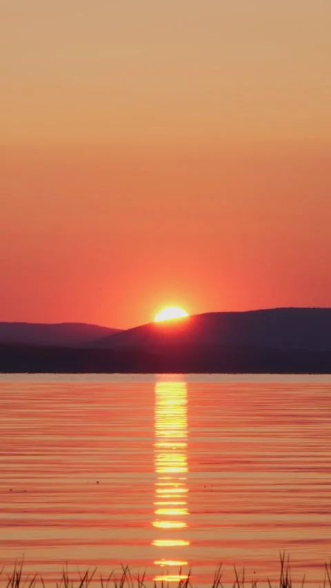 Beautiful sunset on the lake. The sun is setting over the horizon. Stock Footage 267647454