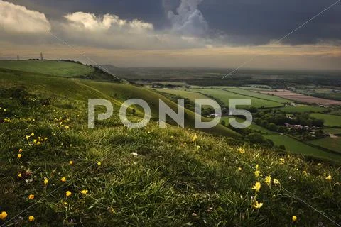 Beautiful sunset landscape image across countryside hills and villages Stock Photos