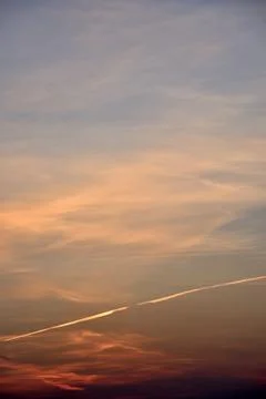 Beautiful sunset light and clouds and a trace of the plane. Evening sunset la Stock Photos