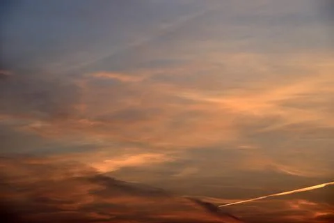 Beautiful sunset light and clouds and a trace of the plane. Evening sunset la Stock Photos