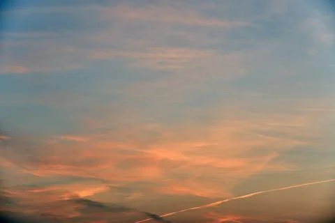 Beautiful sunset light and clouds and a trace of the plane. Evening sunset la Stock Photos