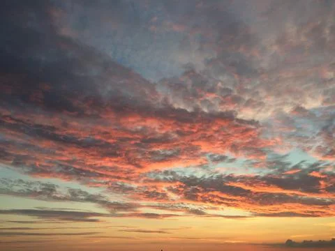Beautiful sunset with light boncing of the clouds Stock Photos