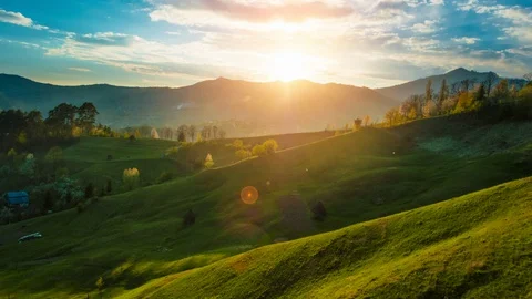 Beautiful sunset light over green grass covered mountain and hills landscape  Stock Footage 129696731