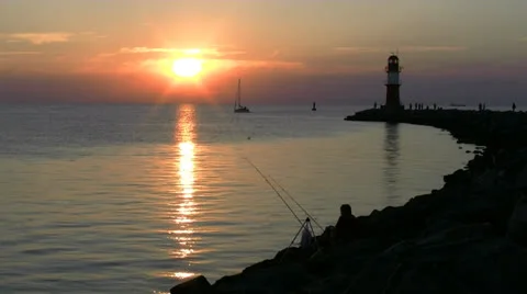 Beautiful Sunset with Lighthouse in Warnemünde - Baltic Sea, Northern Germany Stock Footage 25032734