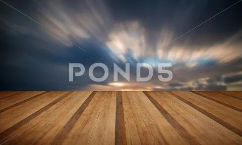 Beautiful sunset long exposure image over ocean with wooden planks floor Stock Photos