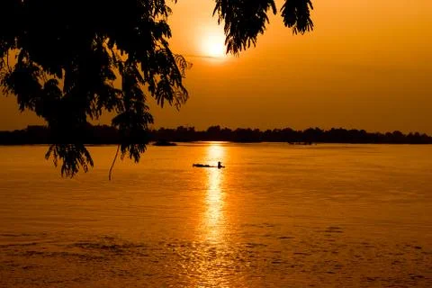 Beautiful sunset in a Mekong River with a fishing boat Stock Photos